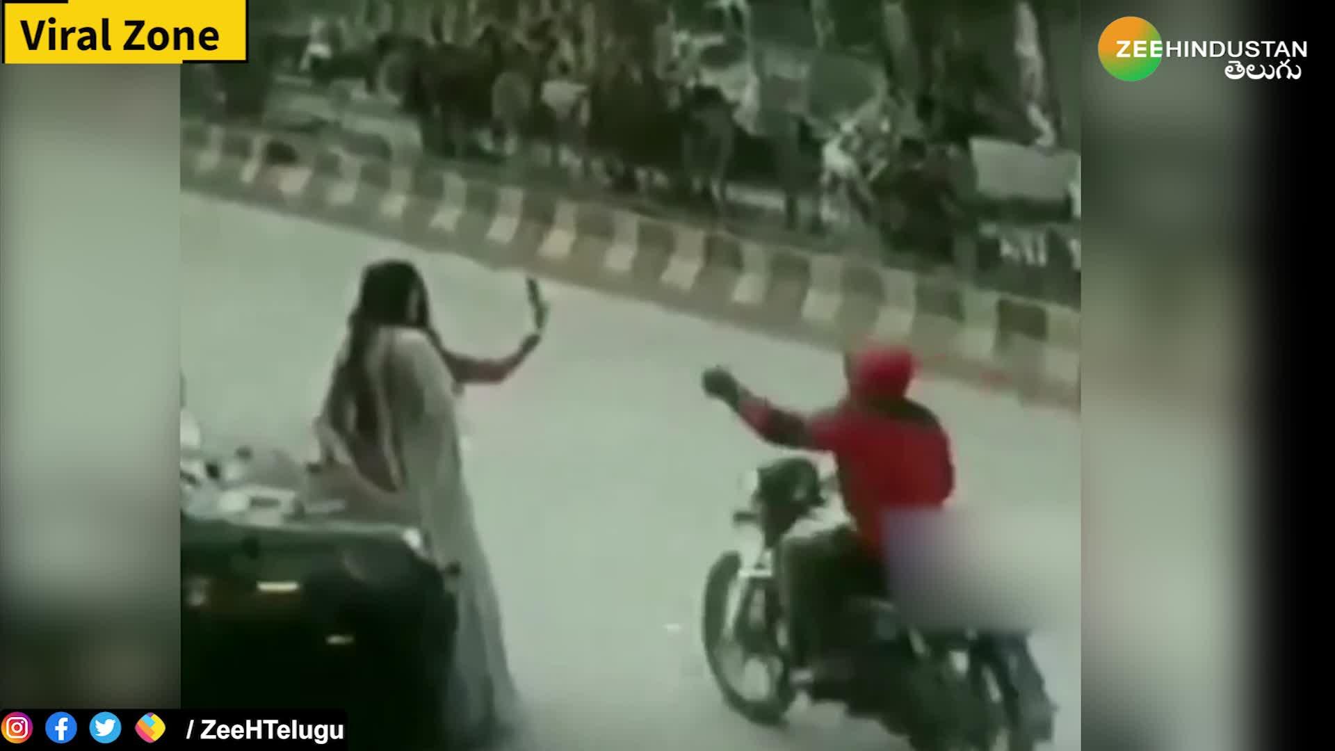 Biker caught on camera snatching mobile phone from two girls while they're taking selfies on road side