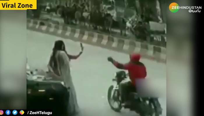 Biker caught on camera snatching mobile phone from two girls while they're taking selfies on road side